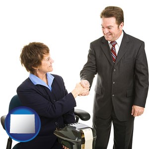 a court reporter shaking hands with an attorney - with Wyoming icon